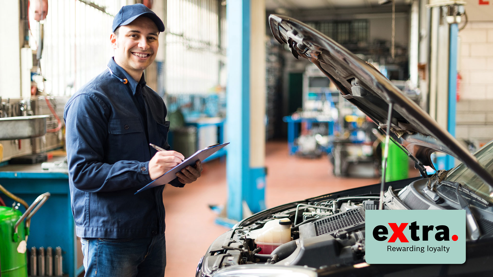 guy working on car in a shop